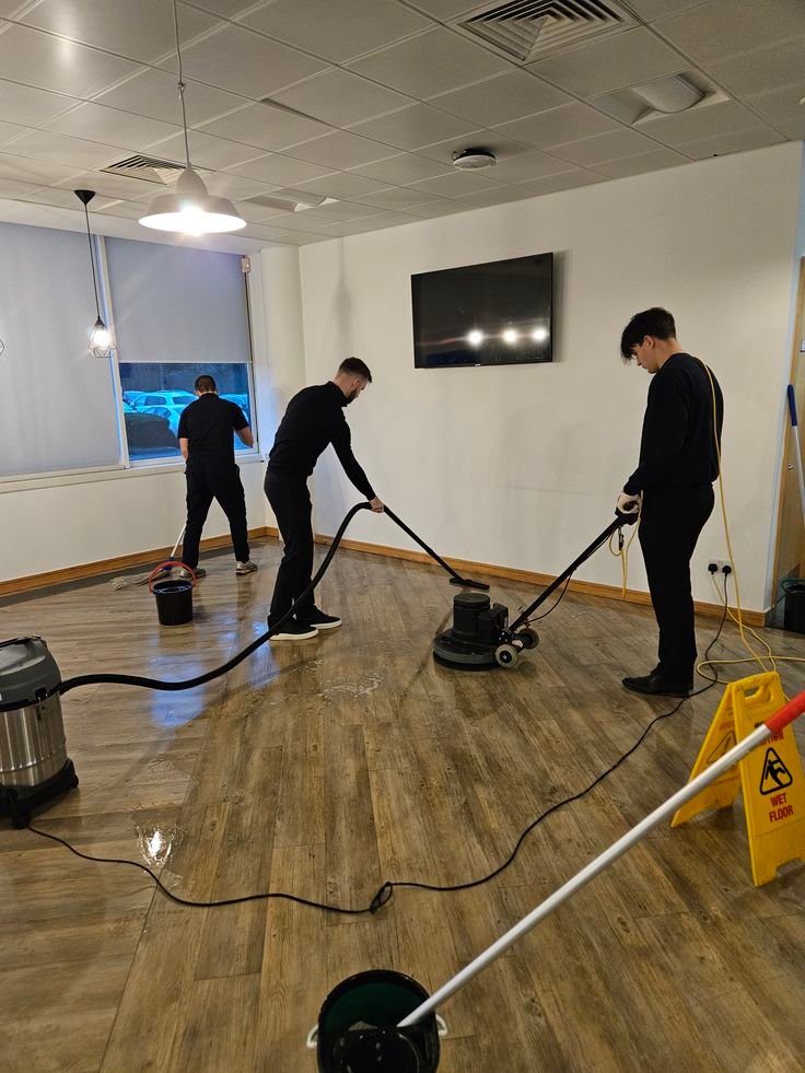Janitorial worker cleaning and sanitizing workplace environment
