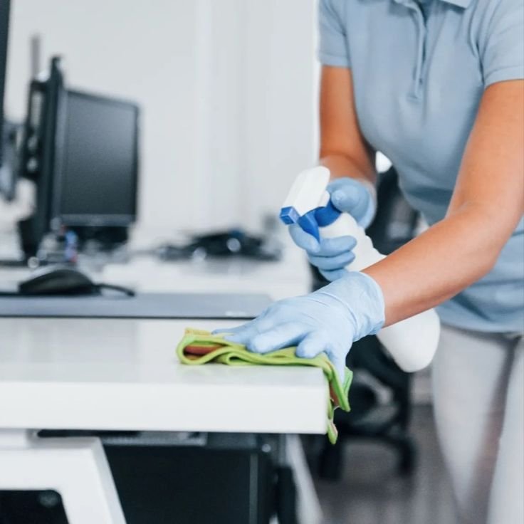 Commercial cleaners sanitizing office space with professional equipment